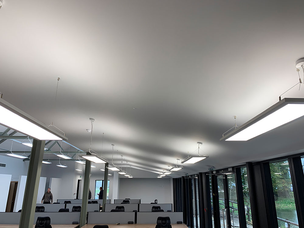 rows of desks with modern strip lights